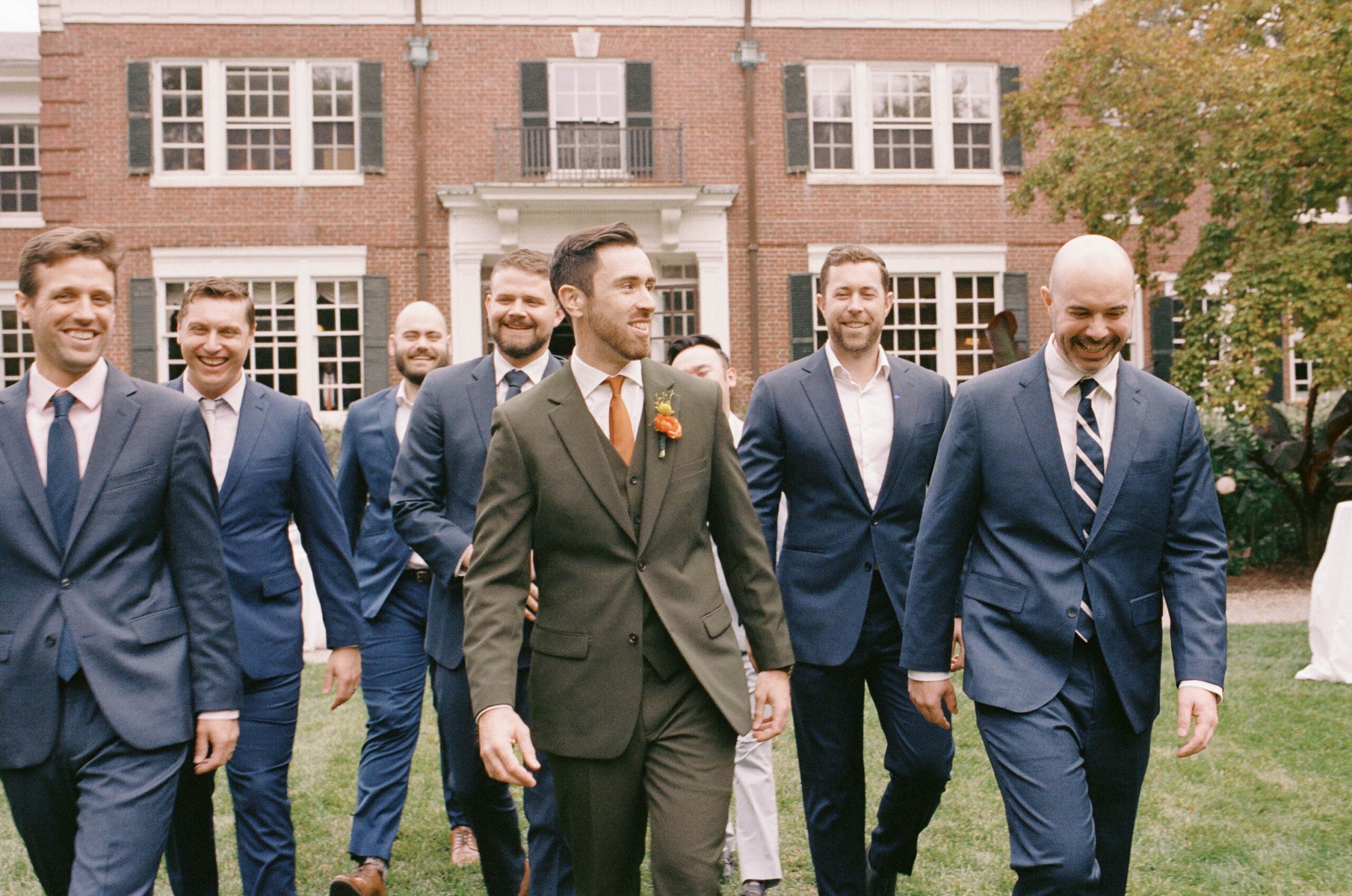 Groomsmen walk in front of bradley estate on film
